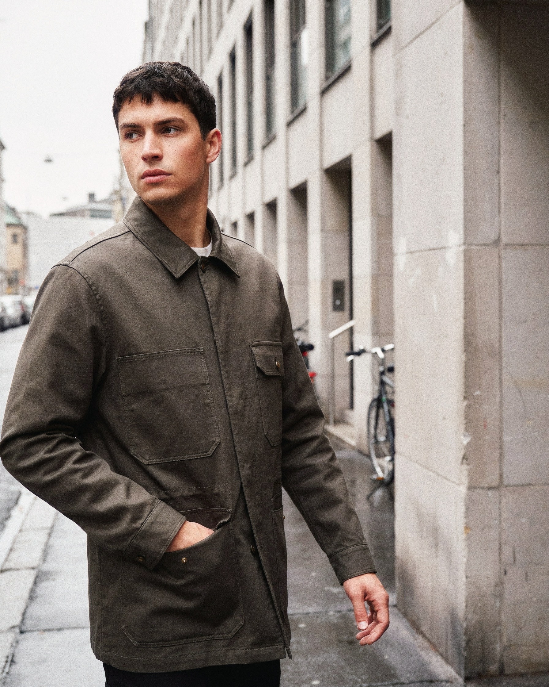 Olive field jacket worn on a city street